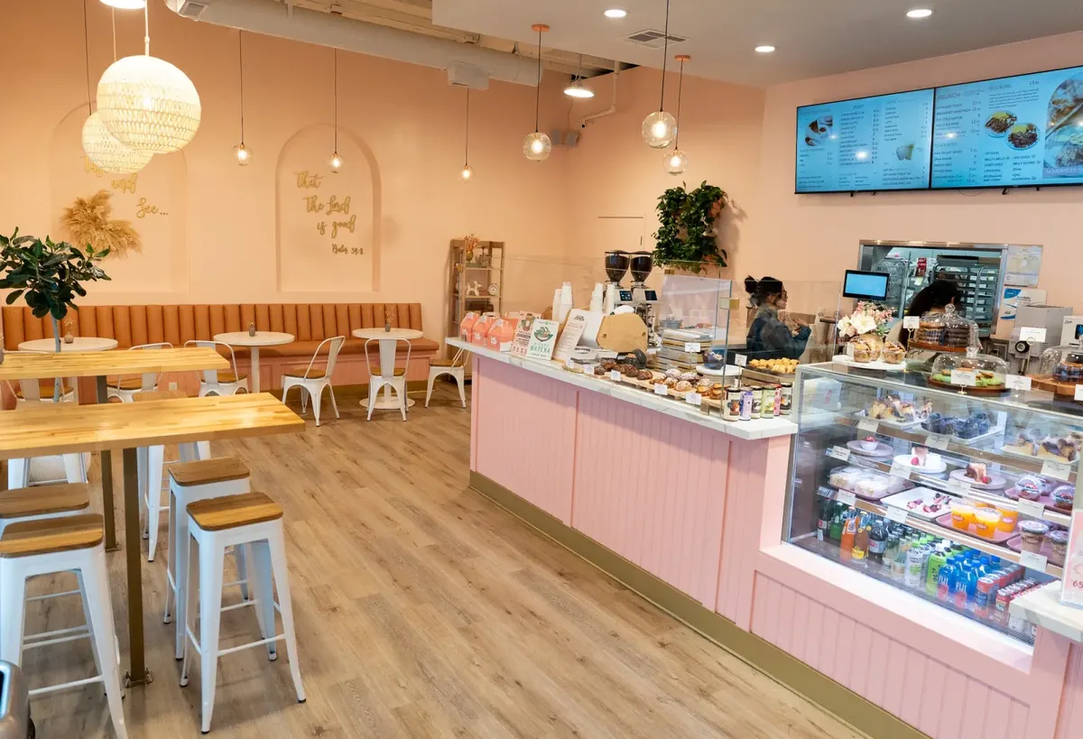Inside +Bake Cafe in Rancho Cucamonga — the pink counter, pastry case, and dining room.